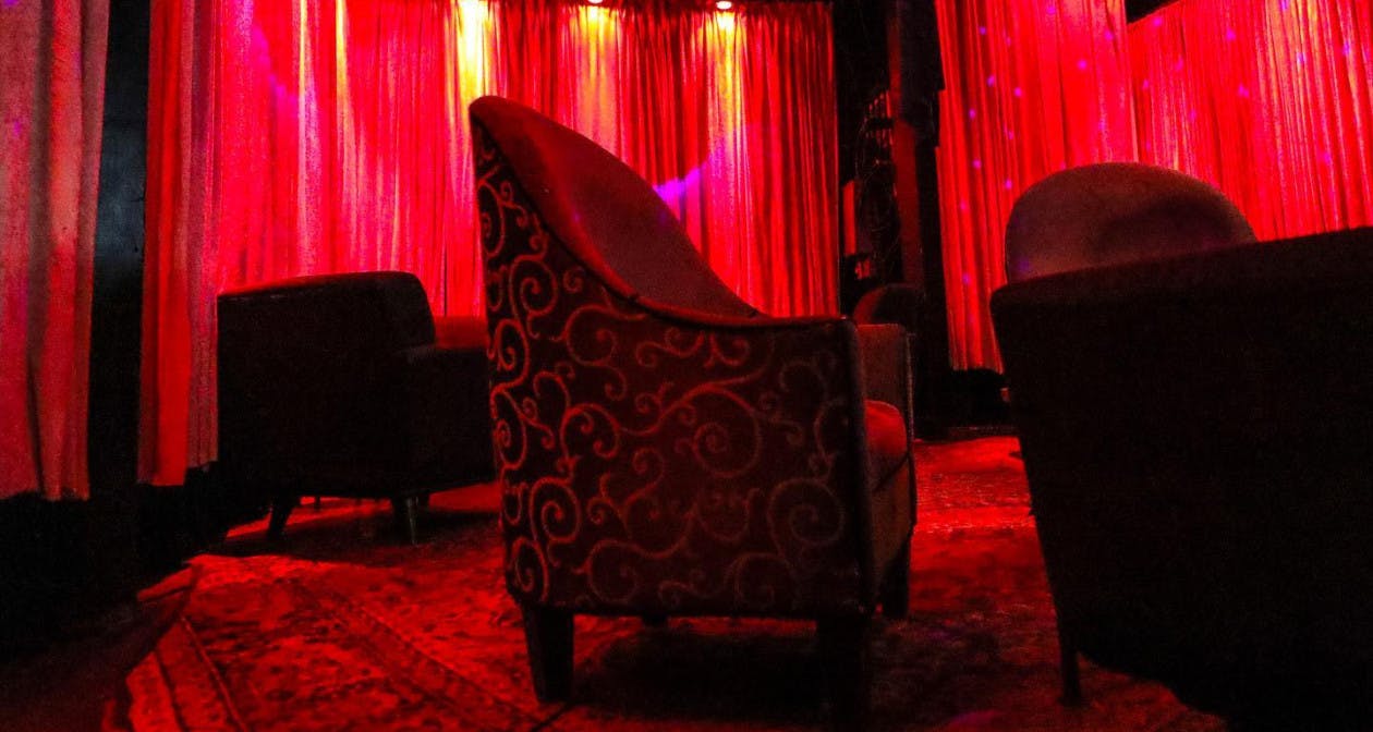 Cozy Boardners venue with warm red lighting, ideal for networking events and gatherings.