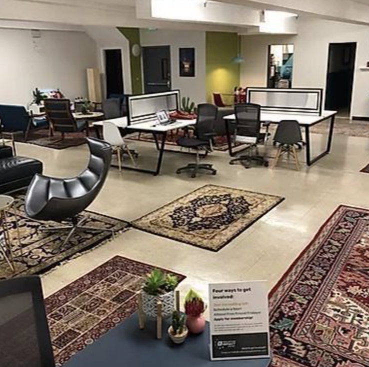 Versatile shared desk in Collective Impact Center, ideal for meetings and collaboration.