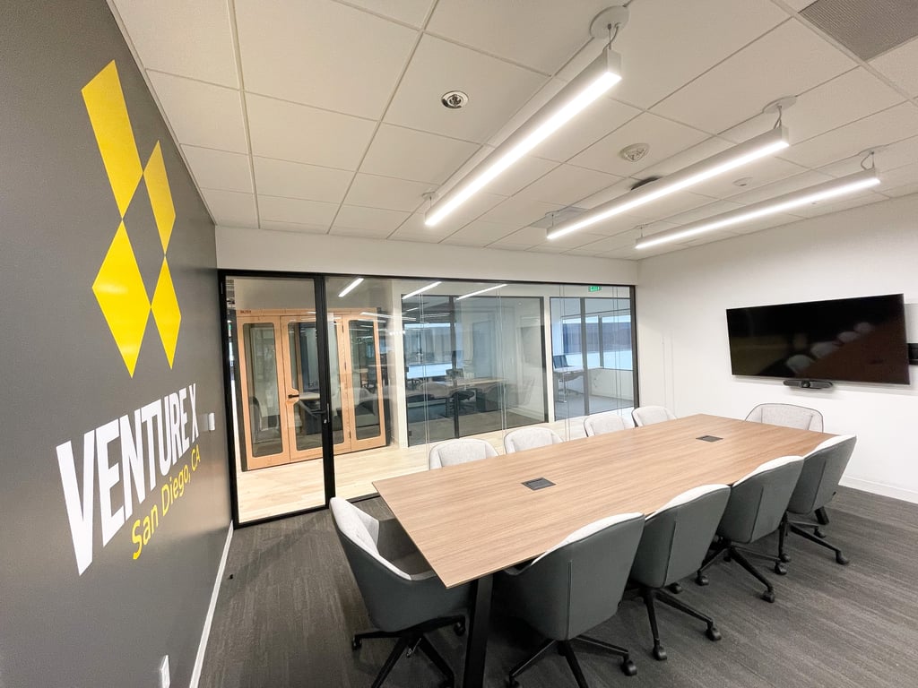 Modern conference room with glass walls for collaborative meetings at Collective Impact Center.