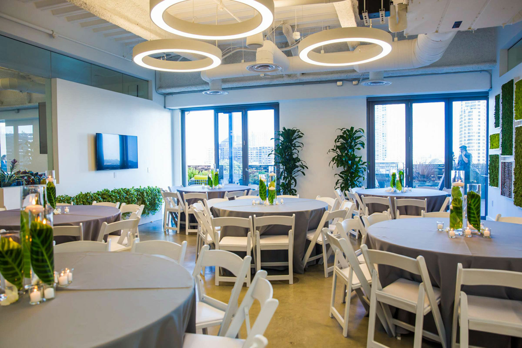 Modern wedding venue with elegant centerpieces and natural light, perfect for events.