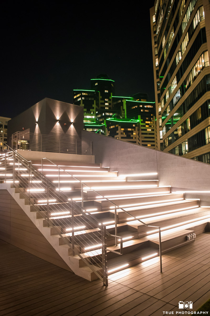 Modern outdoor wedding venue with illuminated stairs and city lights, perfect for receptions.