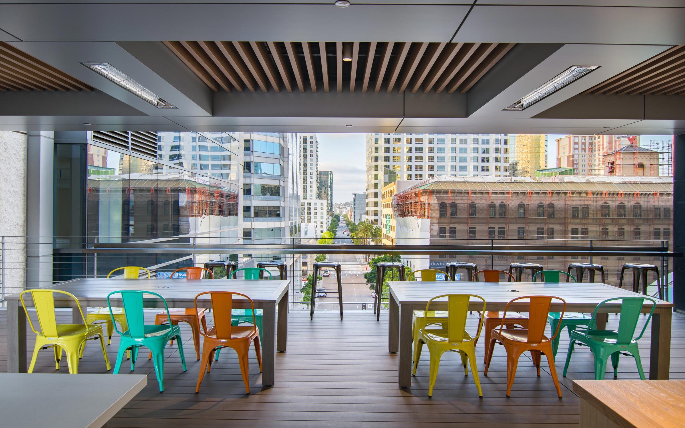 Modern glass-enclosed boardroom with vibrant chairs for networking events at Deck655.