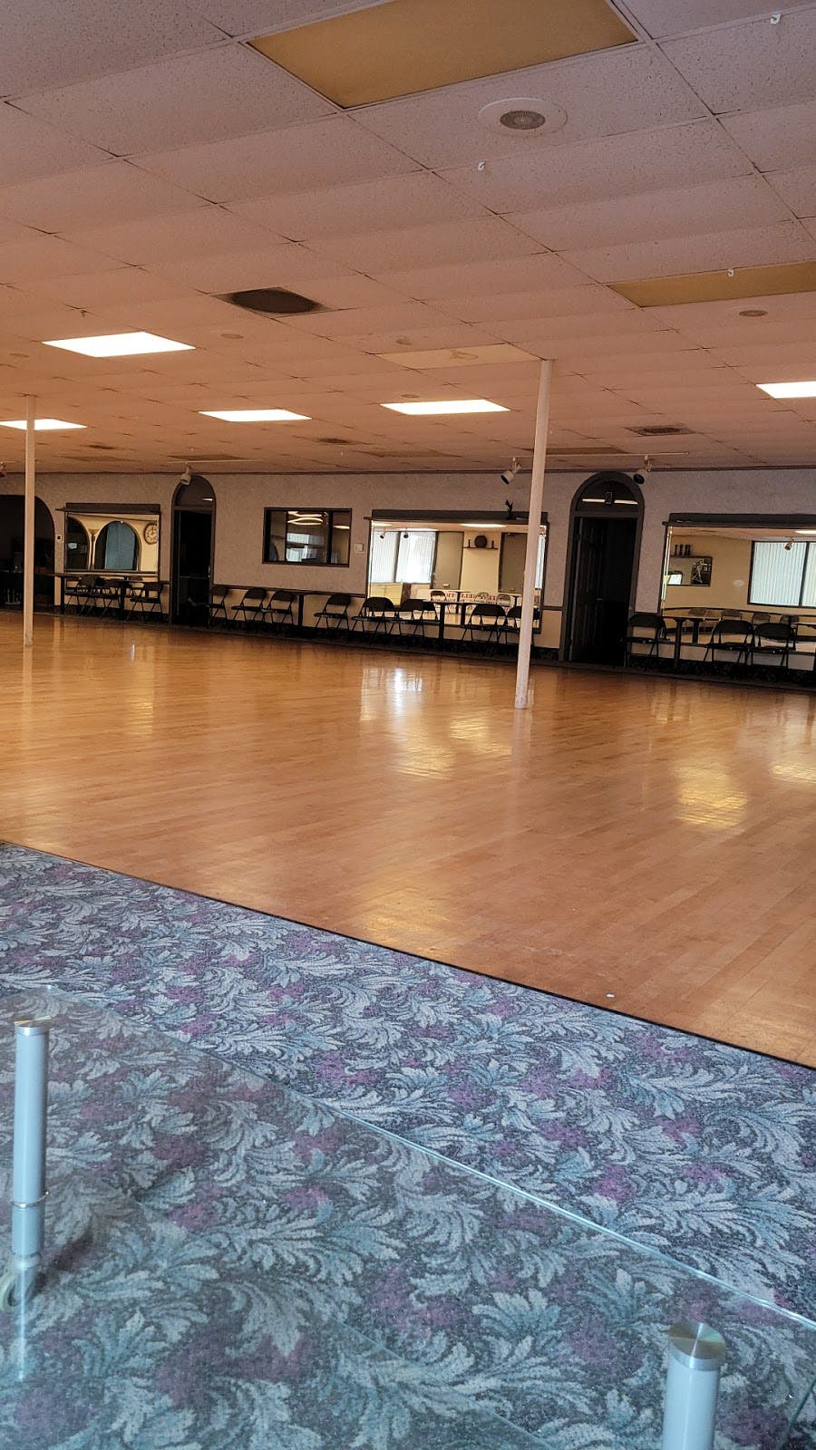 Spacious ballroom with polished floors for versatile events at Starlight Dance Studio.