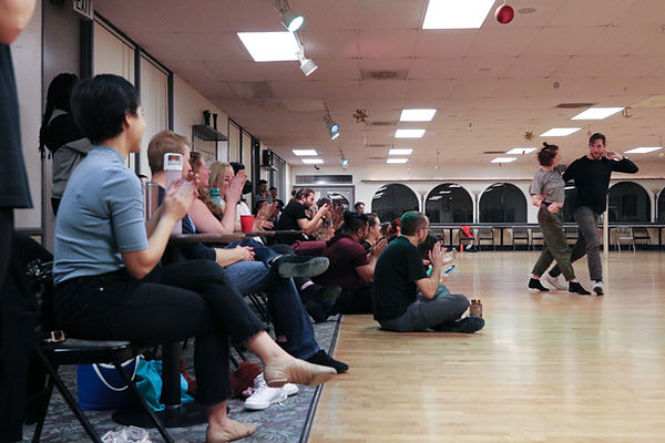Lively dance event at Starlight Dance Studio with engaged audience and dynamic performances.
