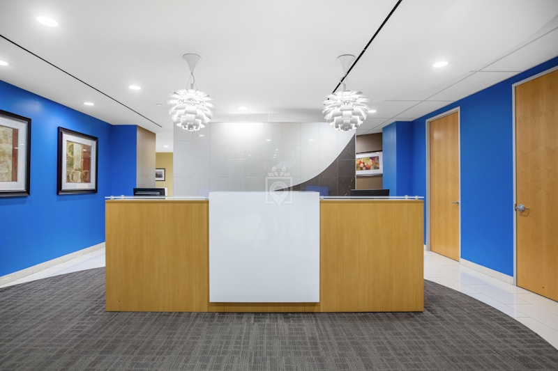 Modern reception area at Regus Pasadena with wooden desk, ideal for meetings and events.