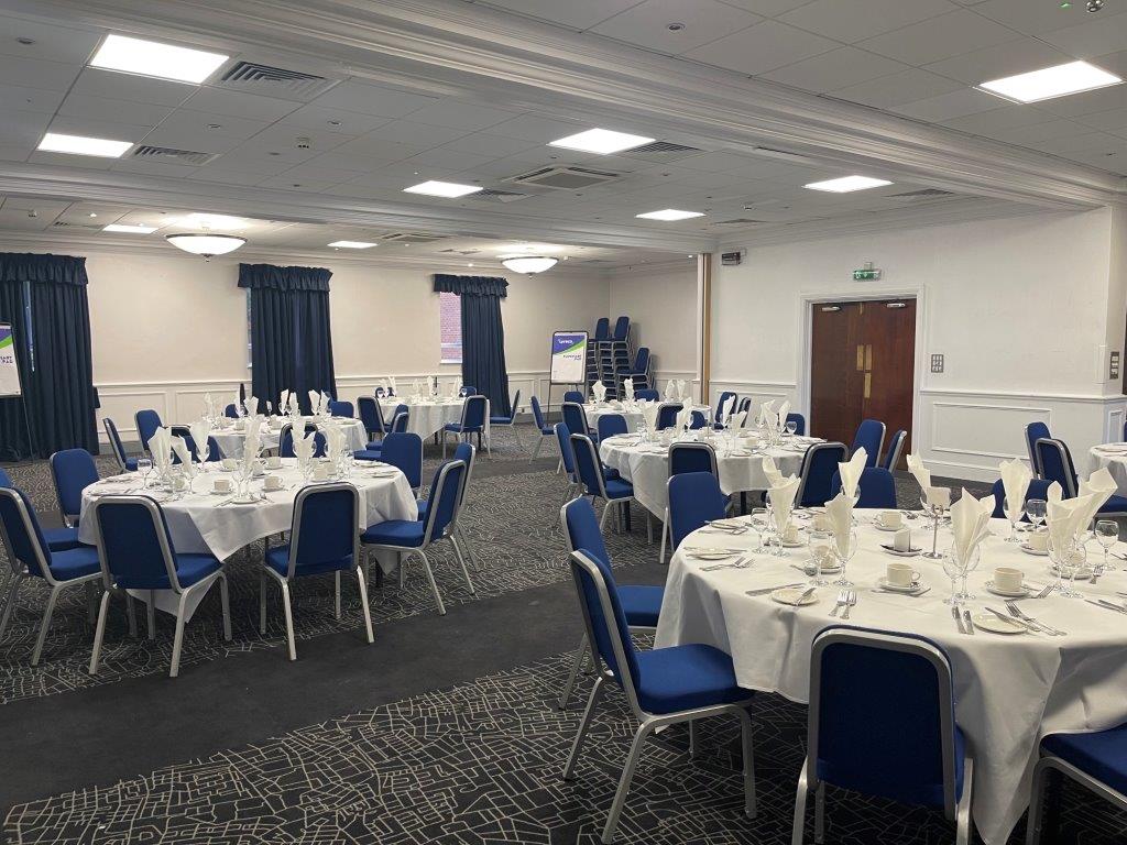 Prince of Wales at Mercure Birmingham: elegant event space with round tables and blue chairs.