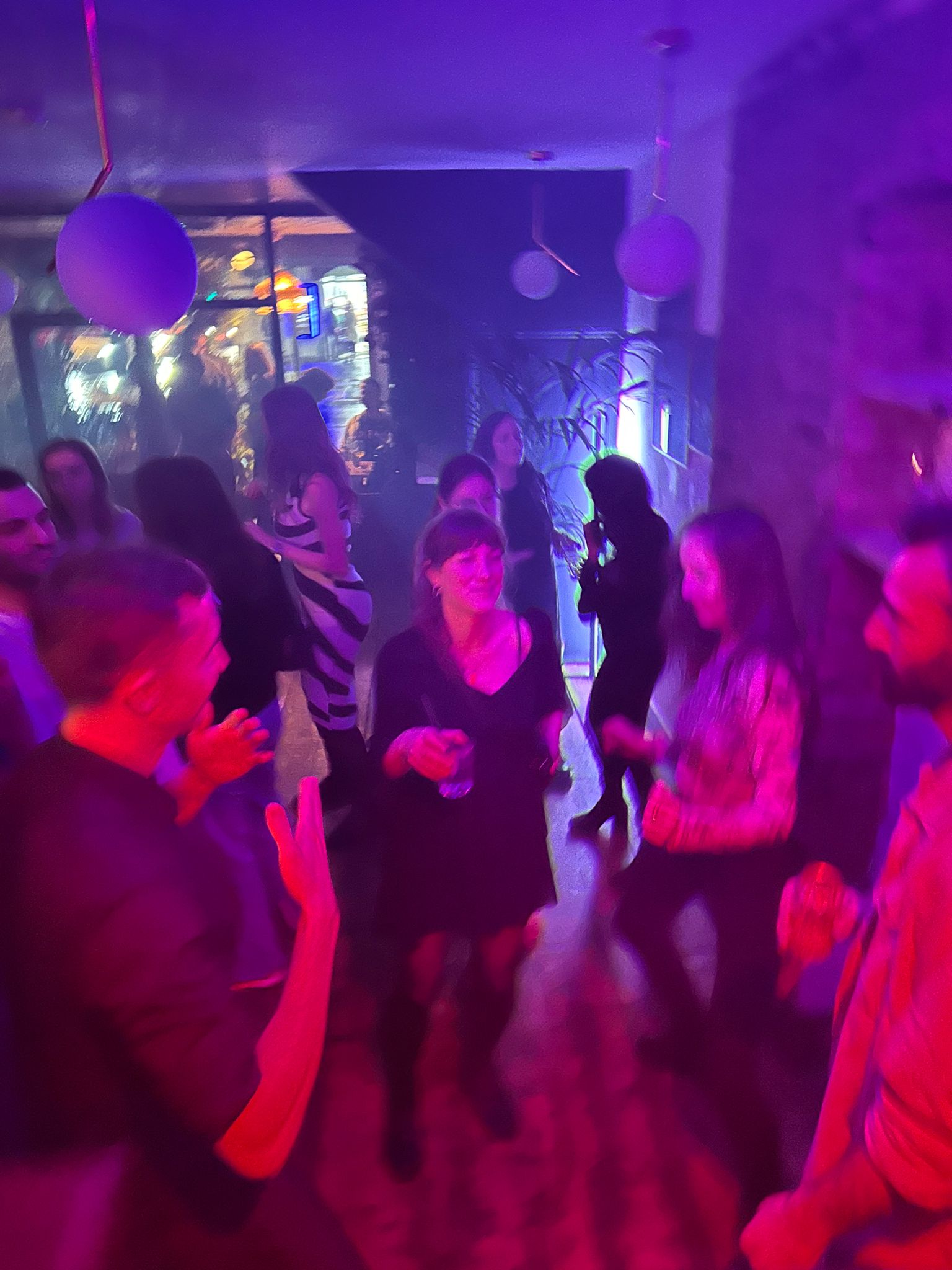 Vibrant social event at Mosaic Clapton Wine Bar with diverse attendees celebrating milestones.