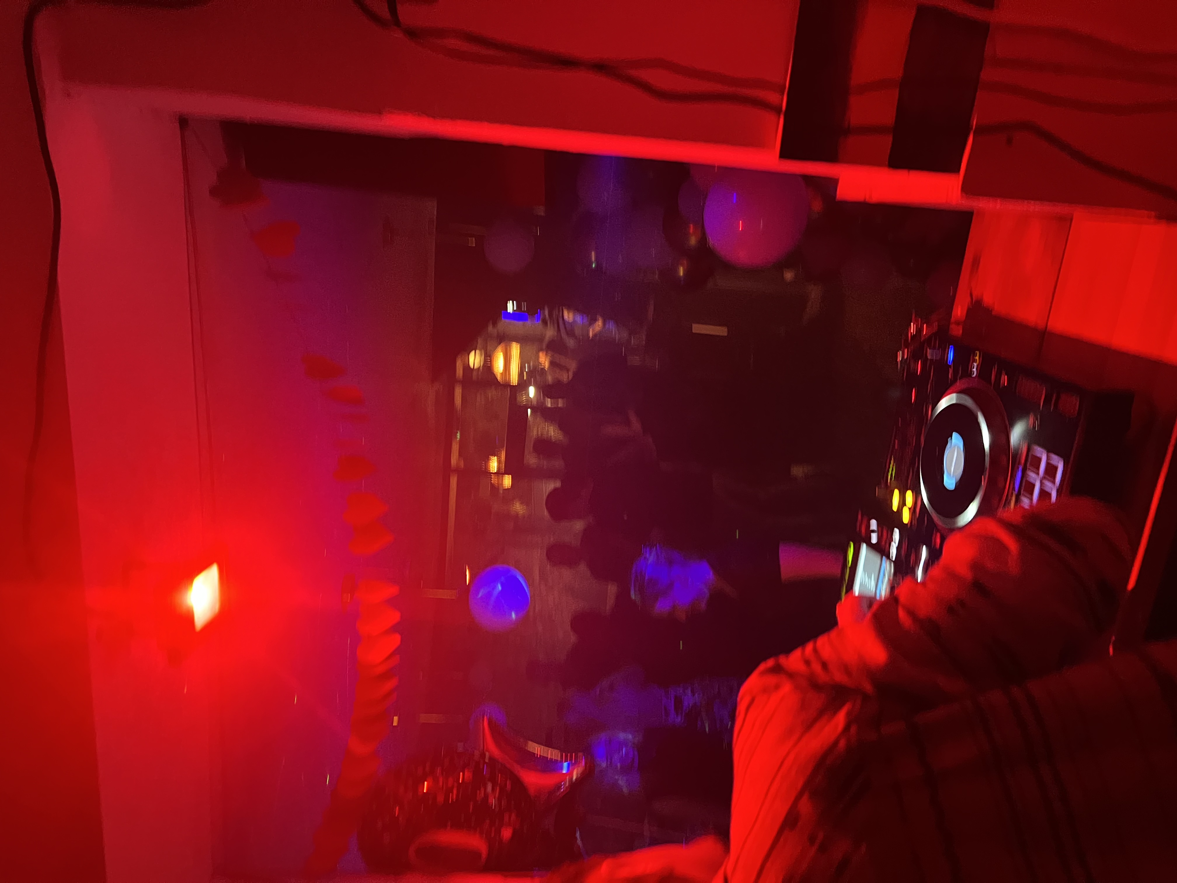 Mosaic Clapton Wine Bar vibrant party scene with colorful decor and DJ setup.