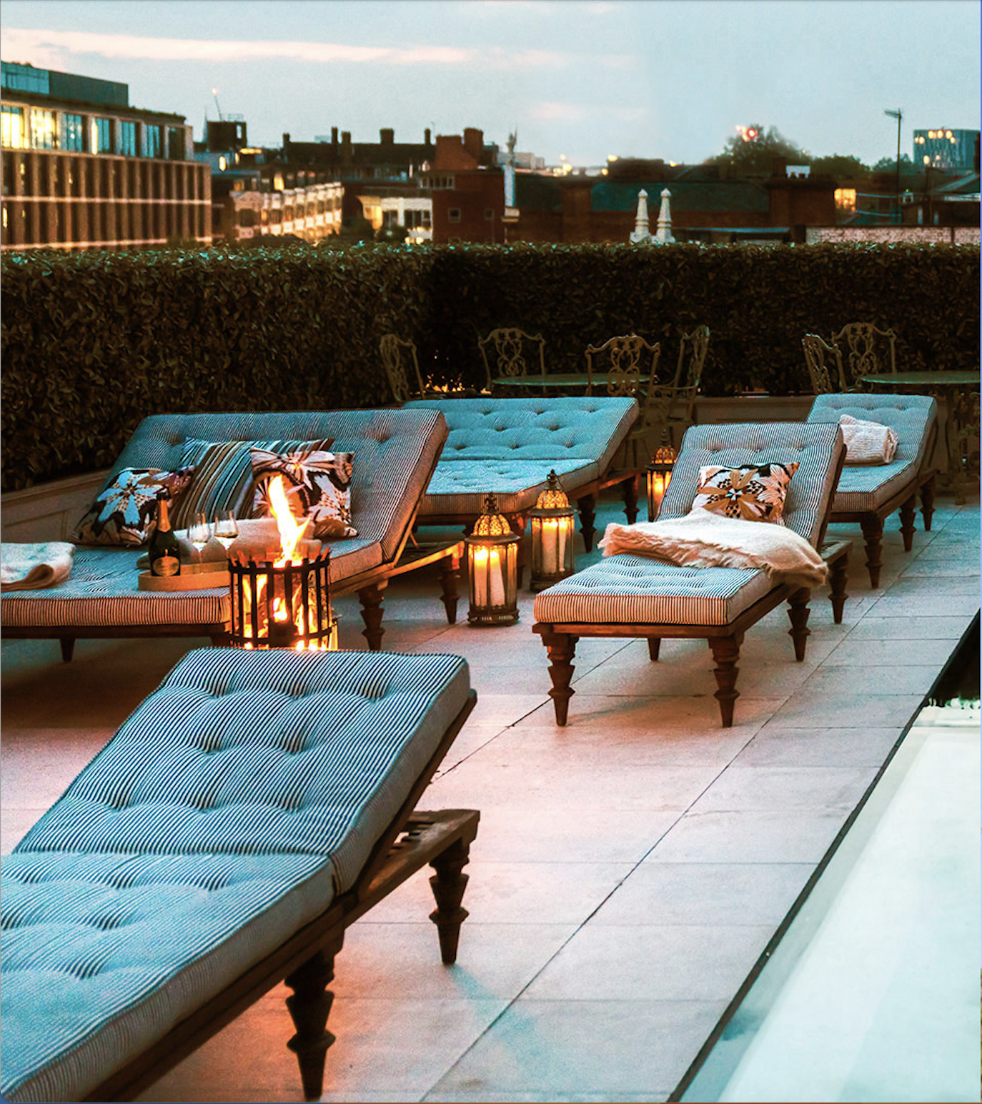 Stylish rooftop lounge with chaise lounges, perfect for networking events and gatherings.