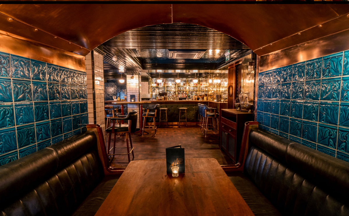 Spitalfields Bar with blue tiles and leather seating, perfect for networking events.