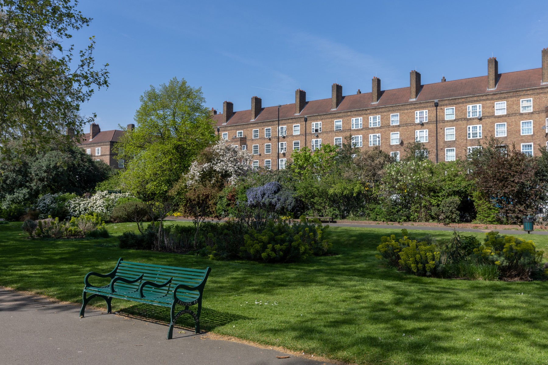 Outdoor space in Kennington Park for networking events, featuring lush greenery and benches.