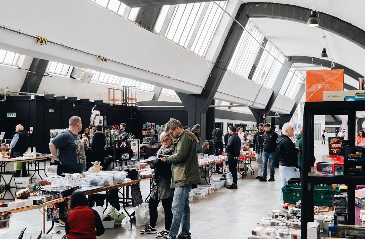 Box Hub Warehouse bustling market event with vendor tables, ideal for trade shows and expos.