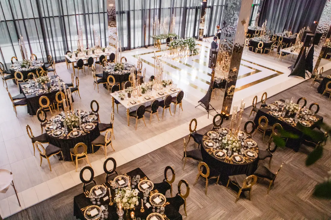 Elegant event space with round tables, perfect for weddings or corporate gatherings.