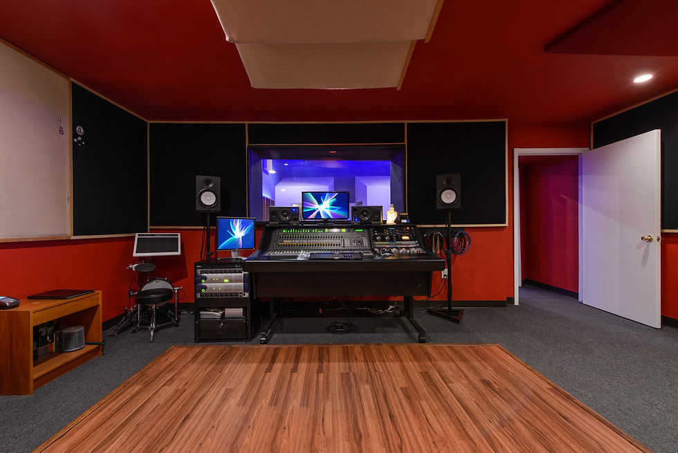 Modern recording studio with red walls, ideal for creative workshops and events.