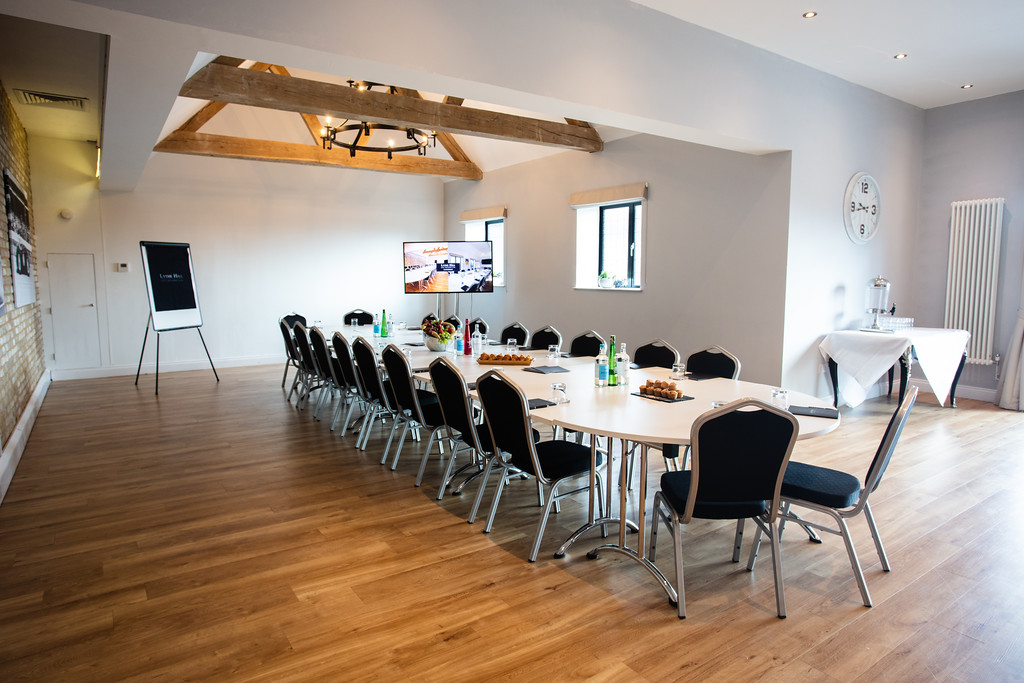 Cedar Suite meeting room at Voco Lythe Hill, featuring a long table and modern decor.