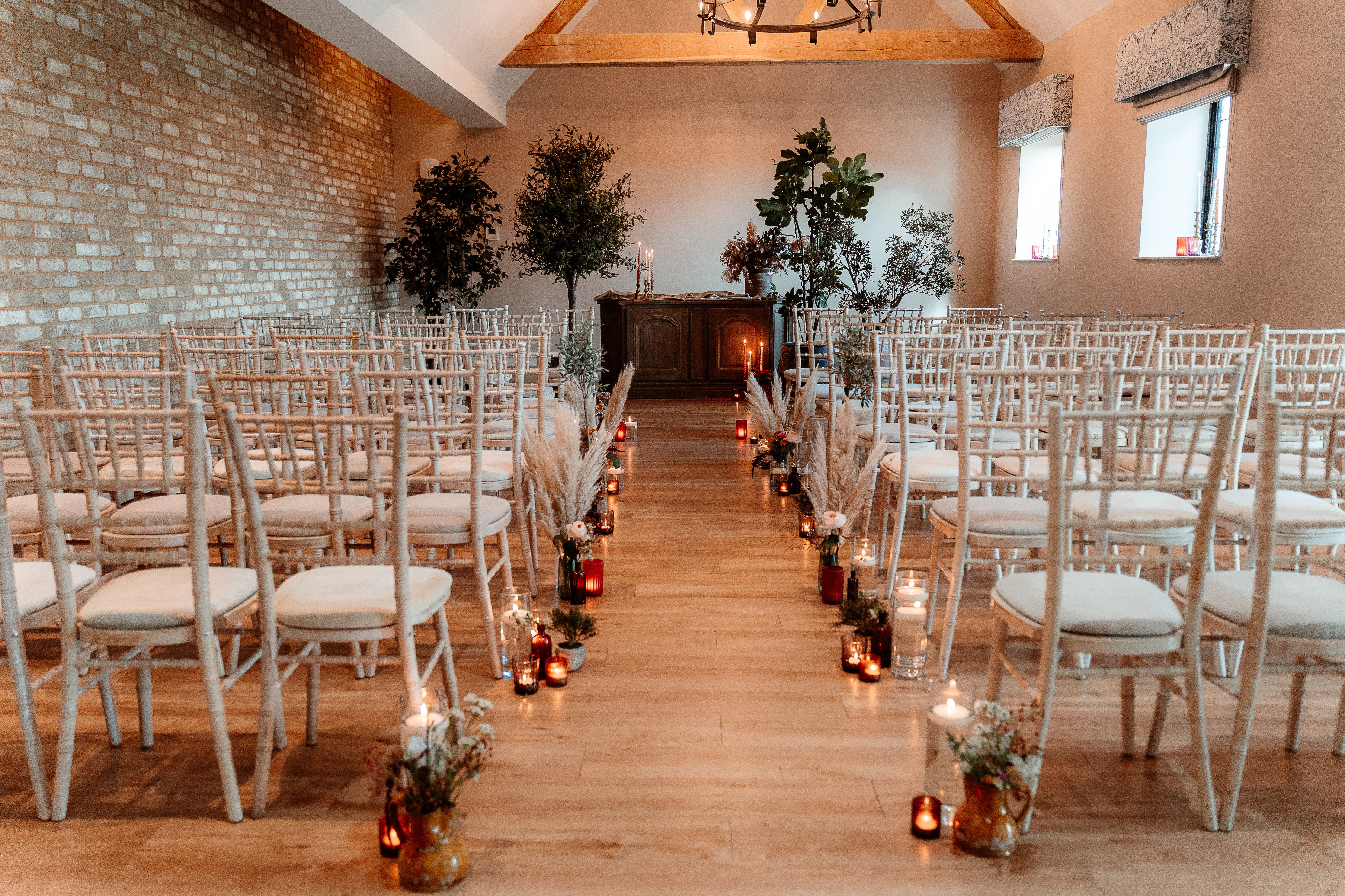 Cedar Suite at Voco Lythe Hill: elegant wedding ceremony space with chiavari chairs.