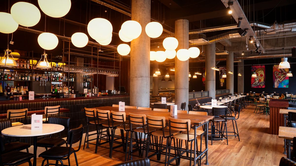 Modern event space at The Sportsman Pub with stylish bar, ideal for networking events.