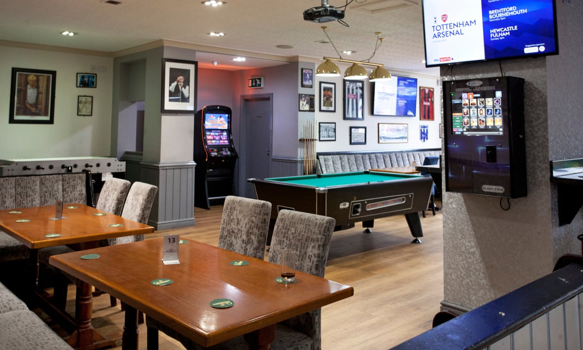 Casual lounge with wooden tables and pool table for social events at The Sportsman Pub.