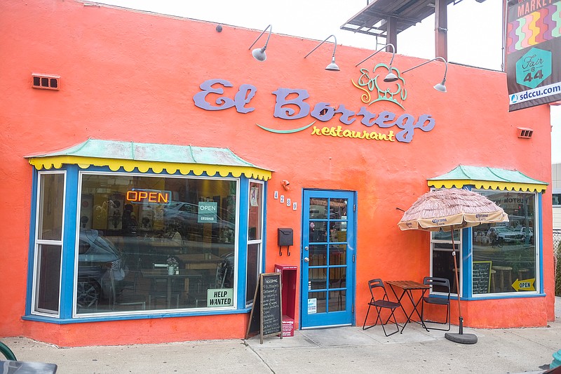 Outdoor patio at JC Bruno Restaurant with colorful facade, ideal for casual events and dining.