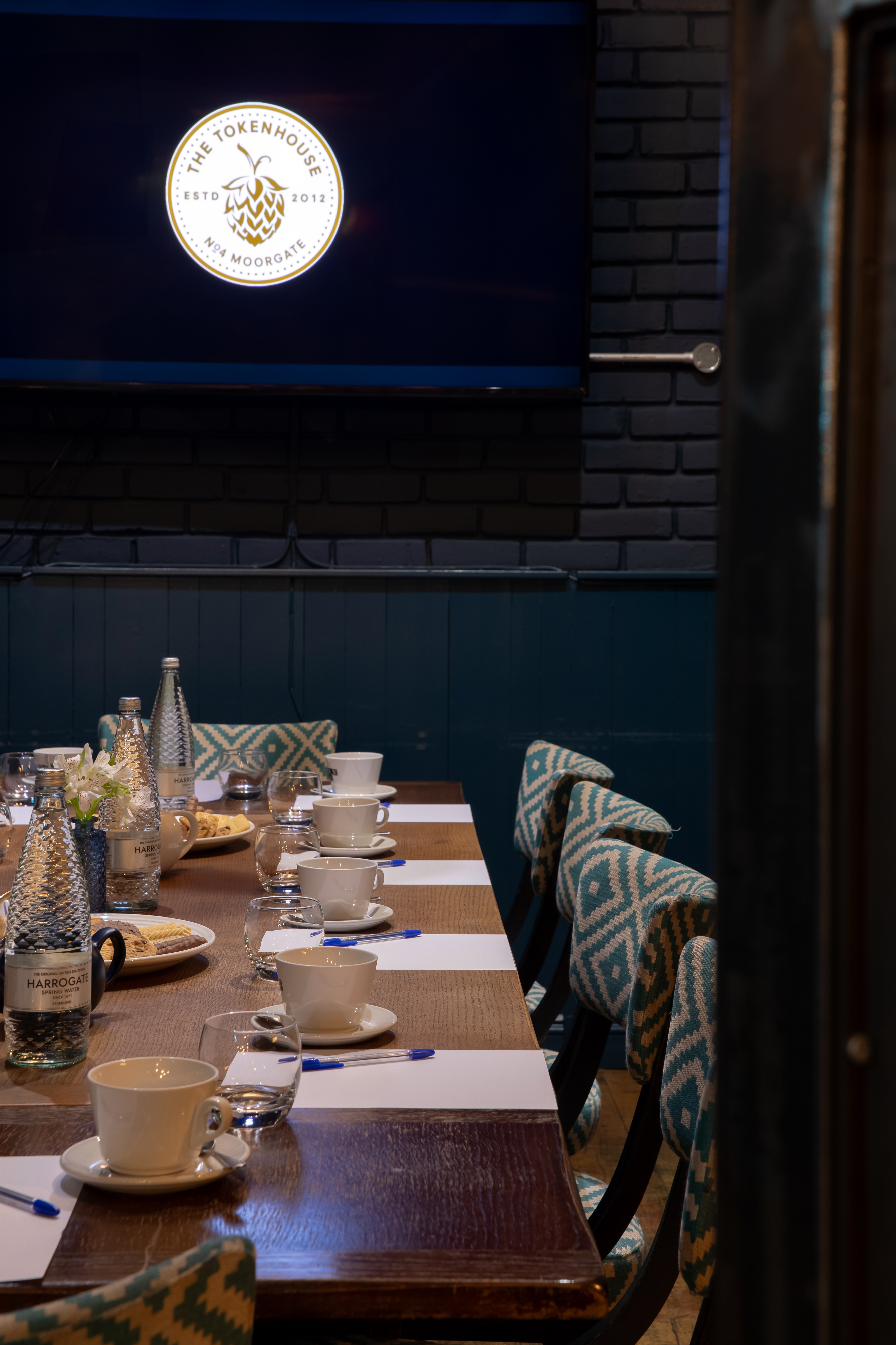 Meeting space at The Tokenhouse with a long wooden table, ideal for networking events.