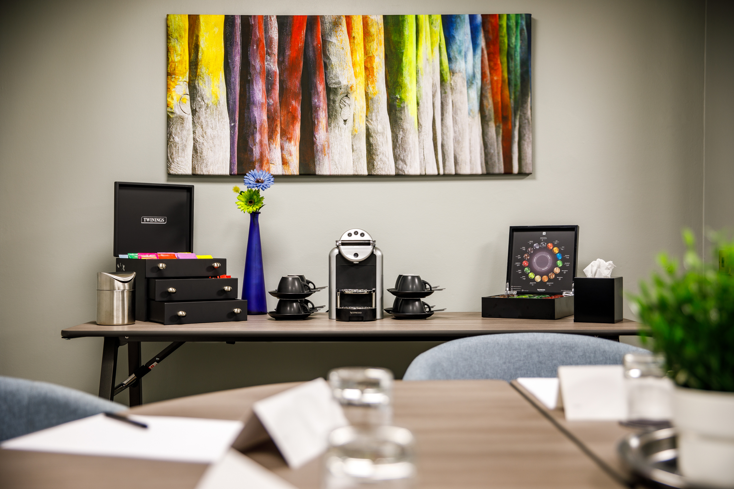 Modern meeting space at Mercure Birmingham West Hotel with coffee station and vibrant decor.