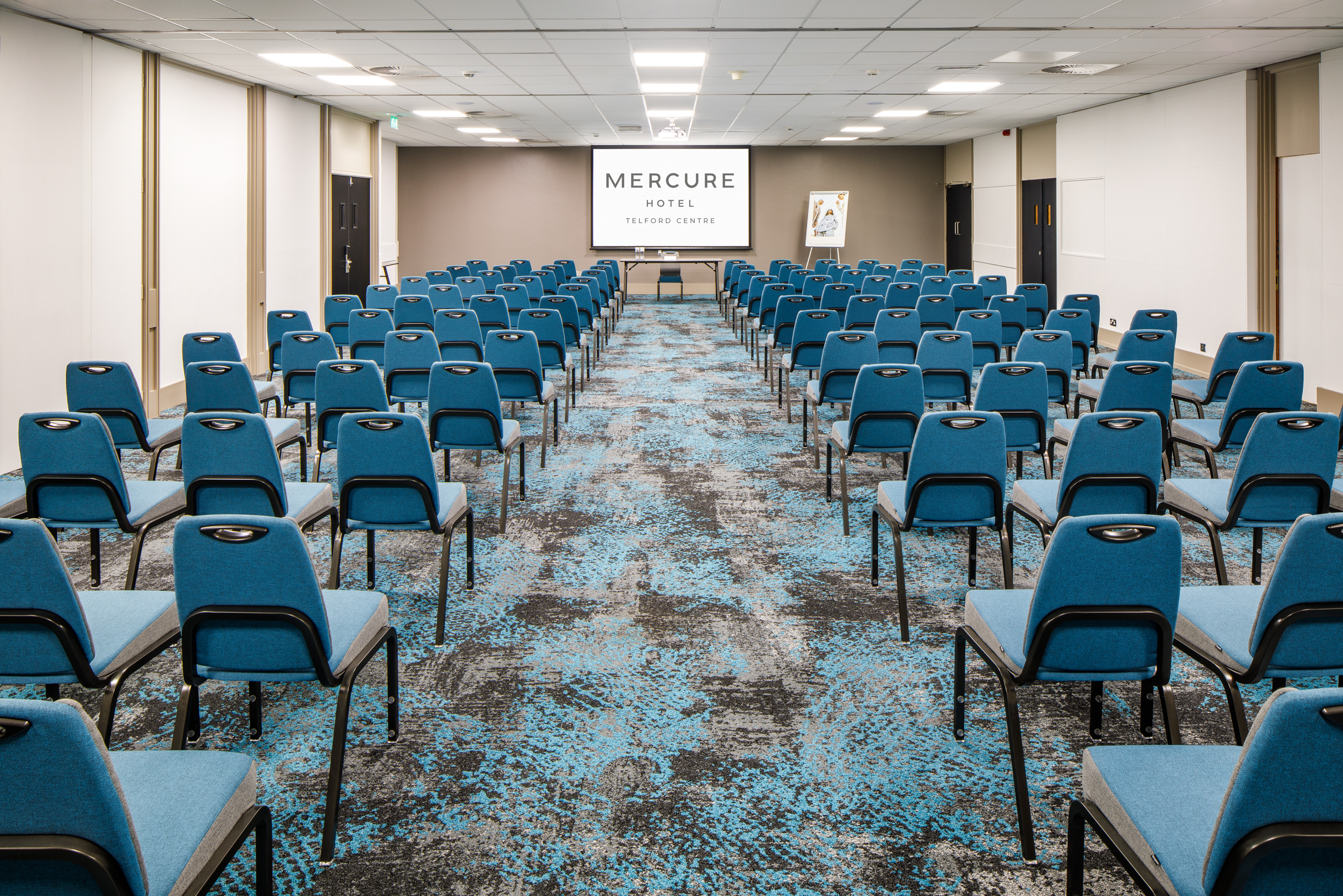 Ironbridge Suite meeting room with blue chairs, ideal for corporate events and conferences.