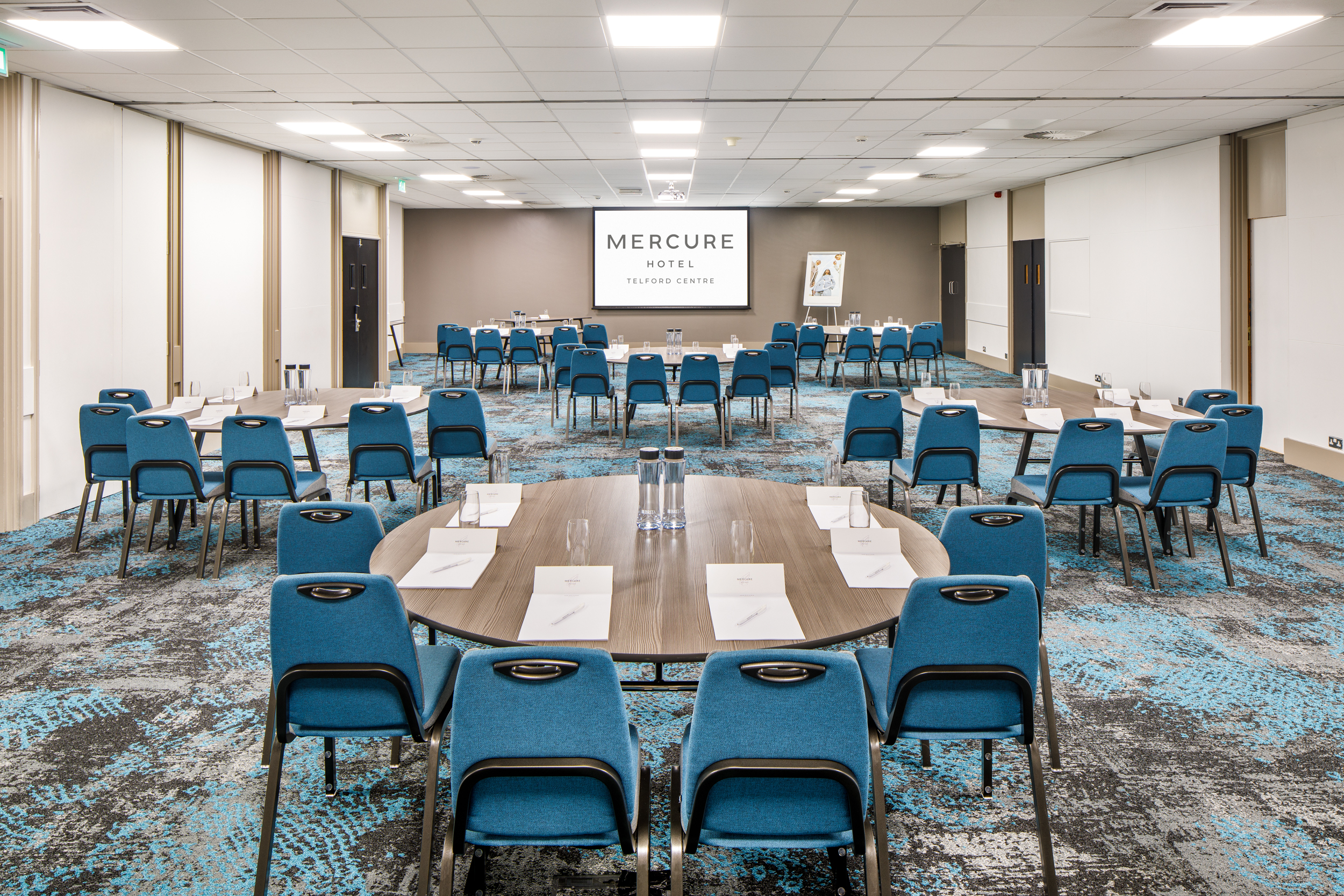 Ironbridge Suite meeting room with blue chairs, ideal for collaborative events.