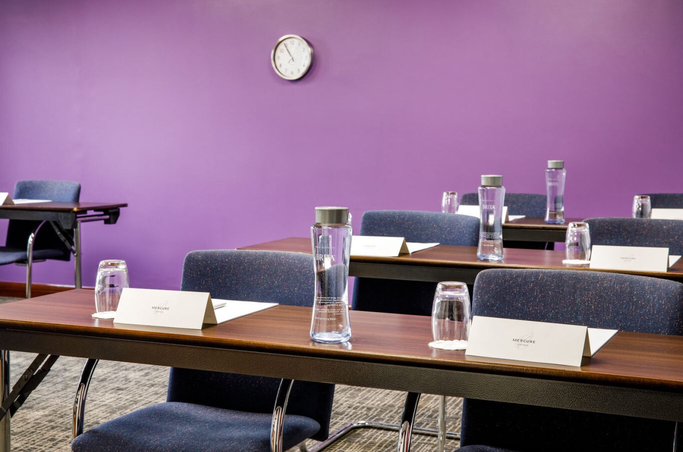 Wenlock Suite meeting room with purple walls, ideal for corporate events and conferences.