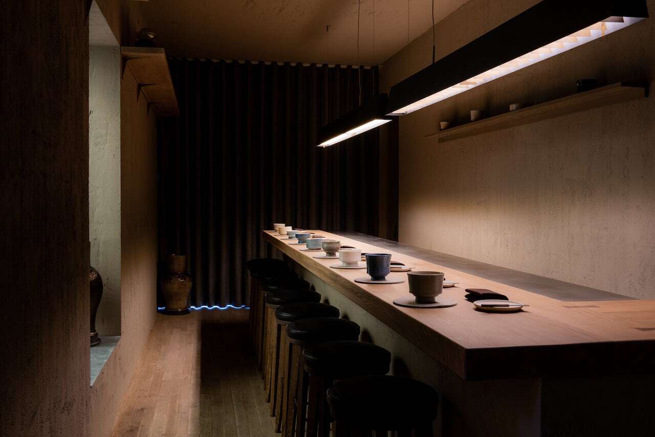 Sleek minimalist meeting space with warm lighting for intimate gatherings and workshops.
