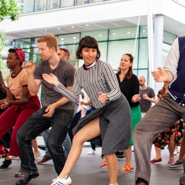 Dynamic dance workshop at Swing Patrol with diverse participants enjoying teamwork.