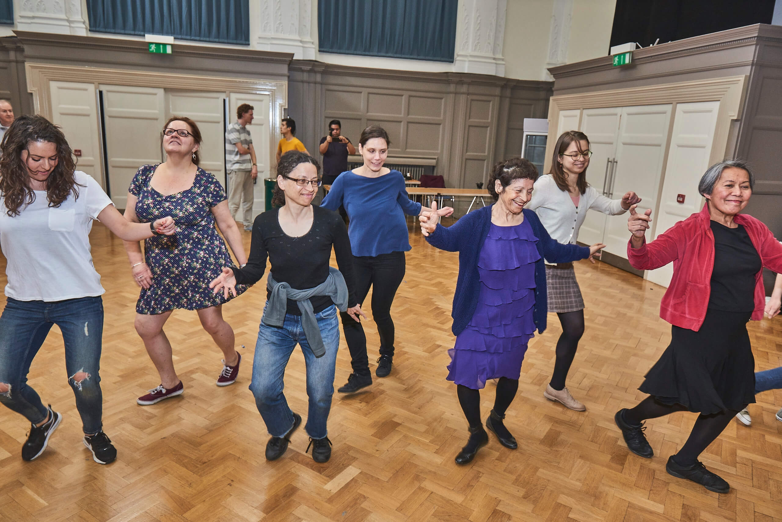 Dance school workshop with diverse participants enjoying team-building activities.