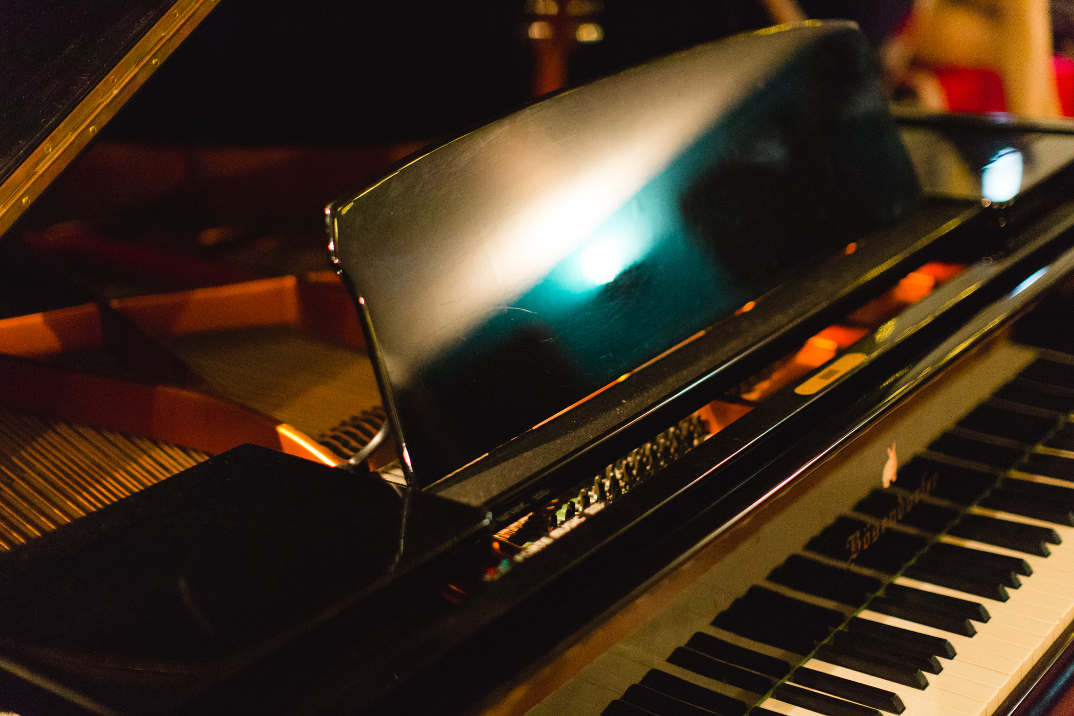 Elegant grand piano in Love Electric recording studio for live music events.