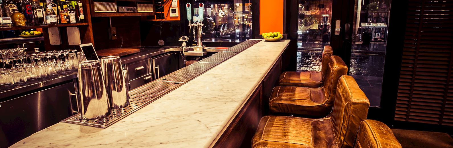 Stylish FAM Bar with marble countertop, perfect for networking events and gatherings.