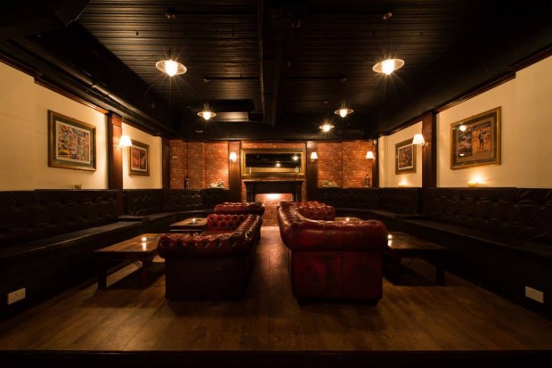 Sophisticated lounge at The Hatch Club with warm lighting, ideal for networking events.