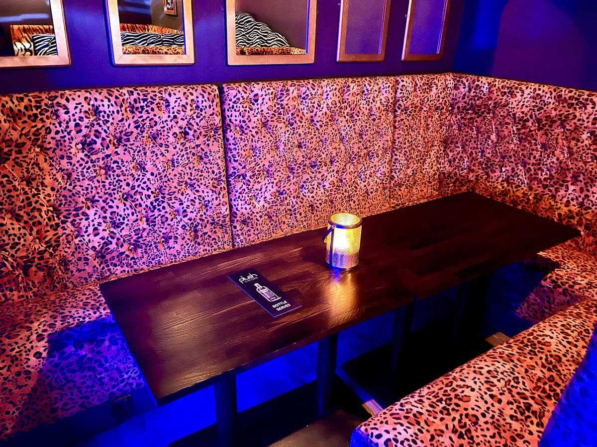 VIP seating area with leopard print upholstery for cocktail receptions and networking events.