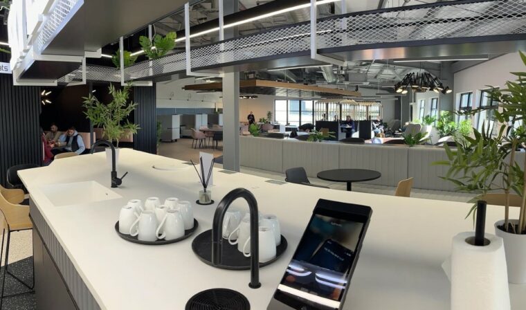 Modern serviced office meeting space with sleek kitchen, ideal for networking events.