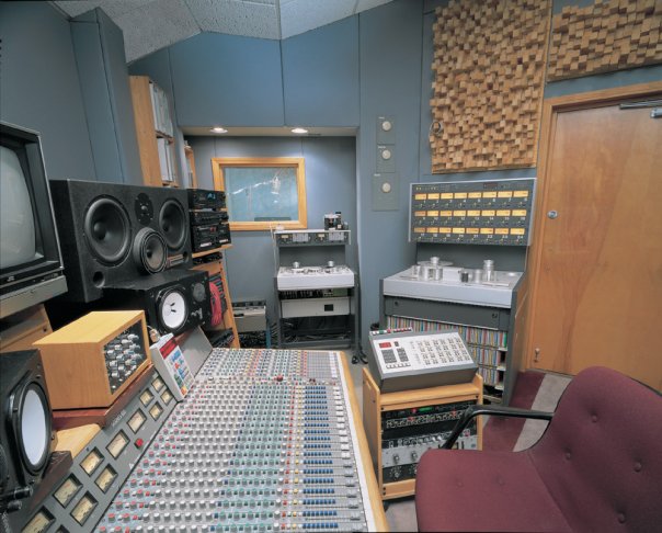 Recording studio audio control room with mixing console for high-quality event production.