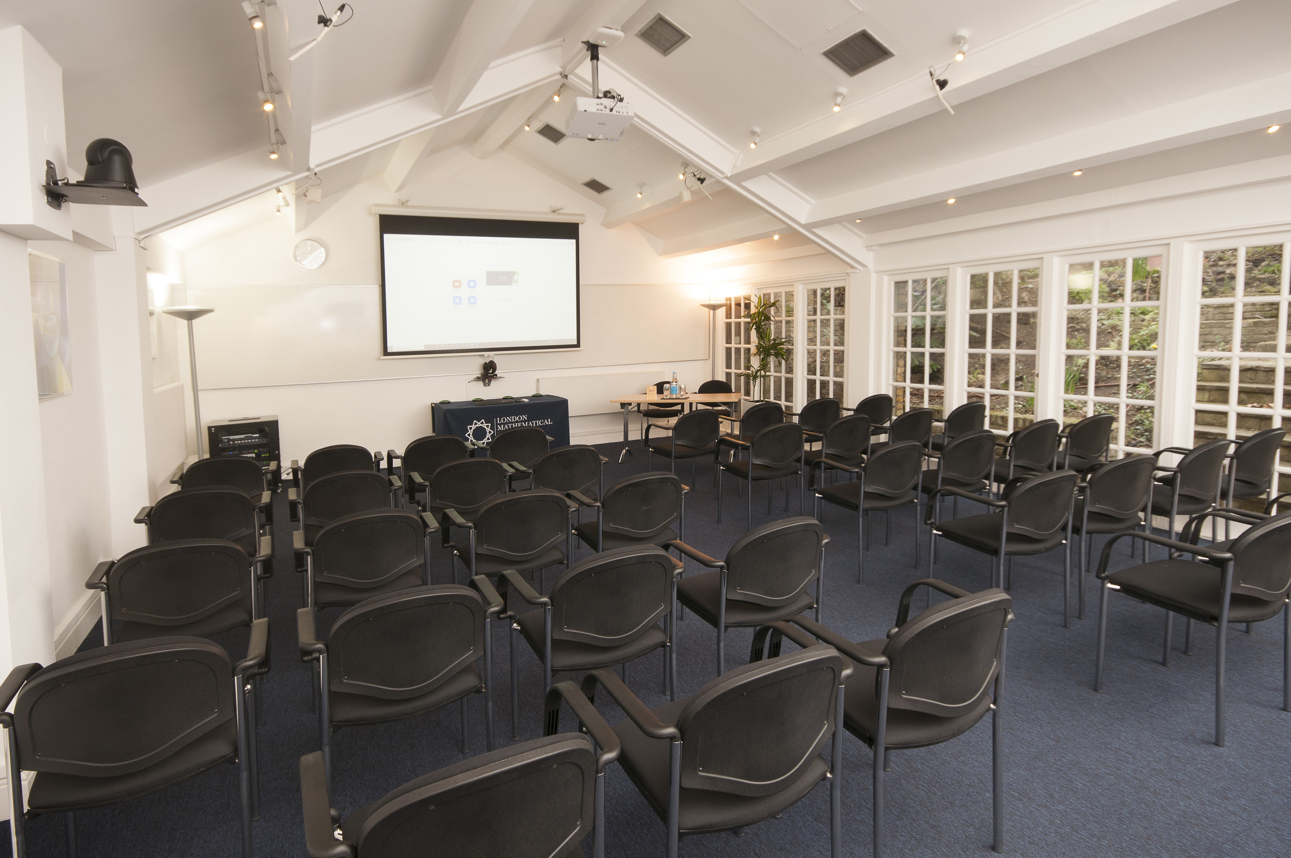 Hardy Room at De Morgan House, bright meeting space with projector for workshops.
