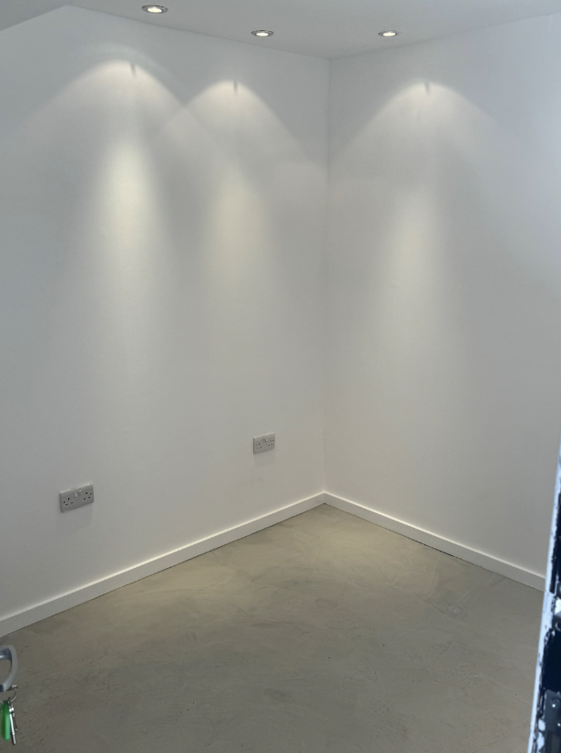 Minimalist meeting space with white walls for intimate gatherings and brainstorming sessions.