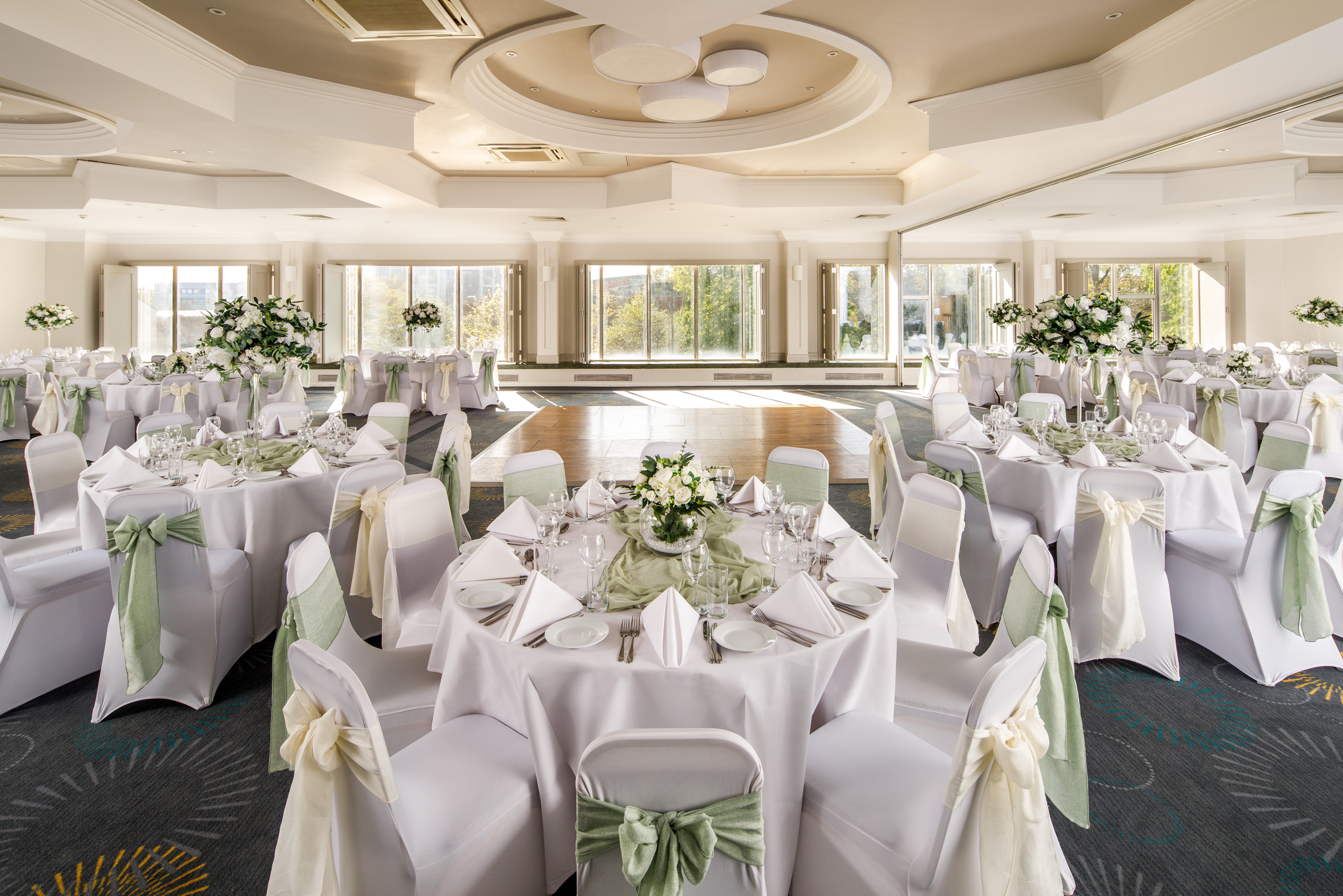Elegant County Suite at Mercure Bedford for weddings and formal events, featuring round tables.