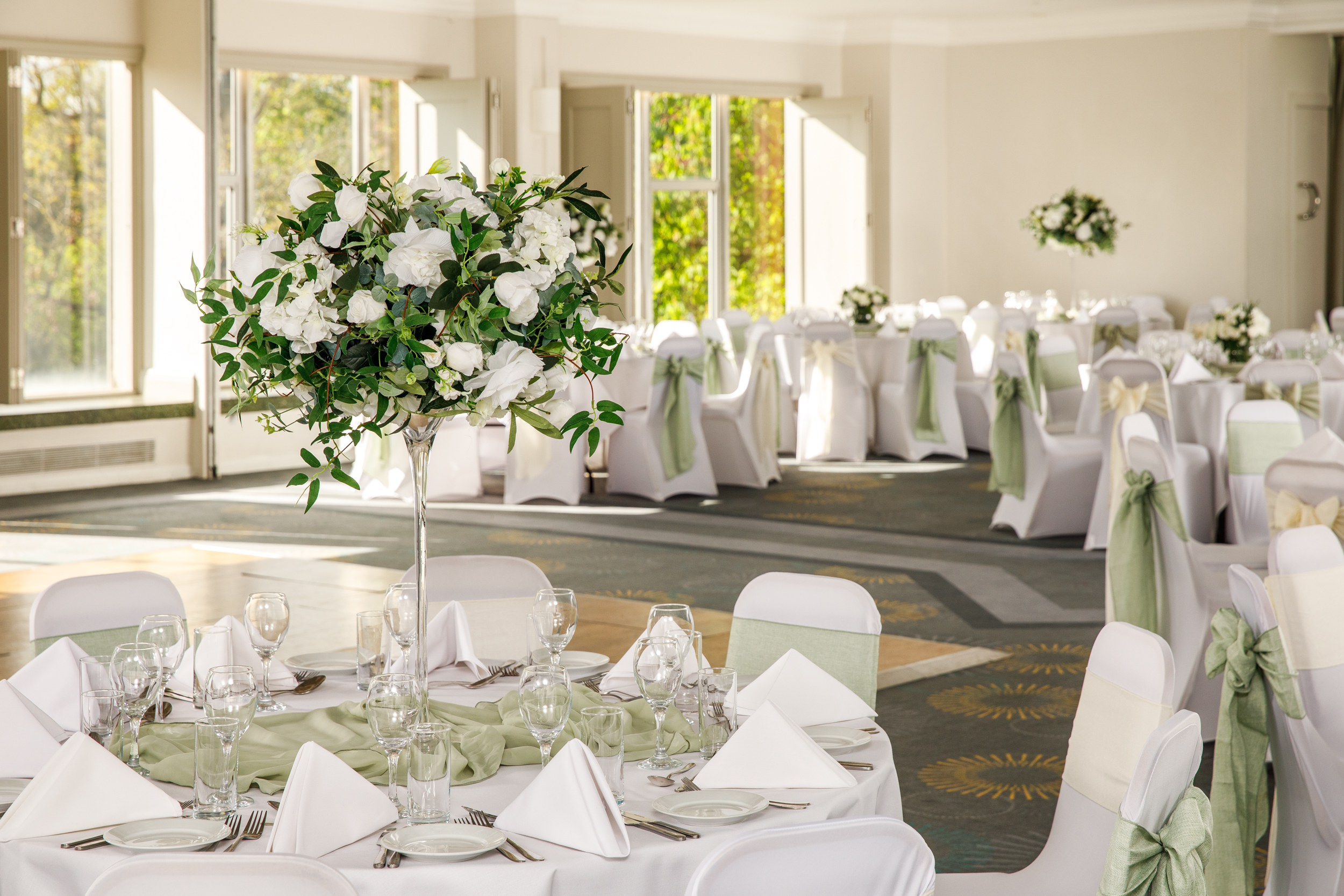 Elegant County Suite at Mercure Bedford for weddings and formal events, featuring floral centerpieces.