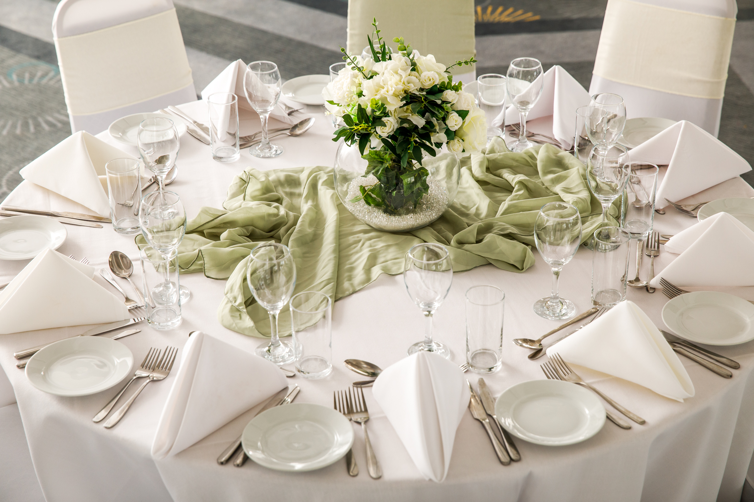Elegant round table setup with fresh flowers at Mercure Bedford Centre Hotel event.
