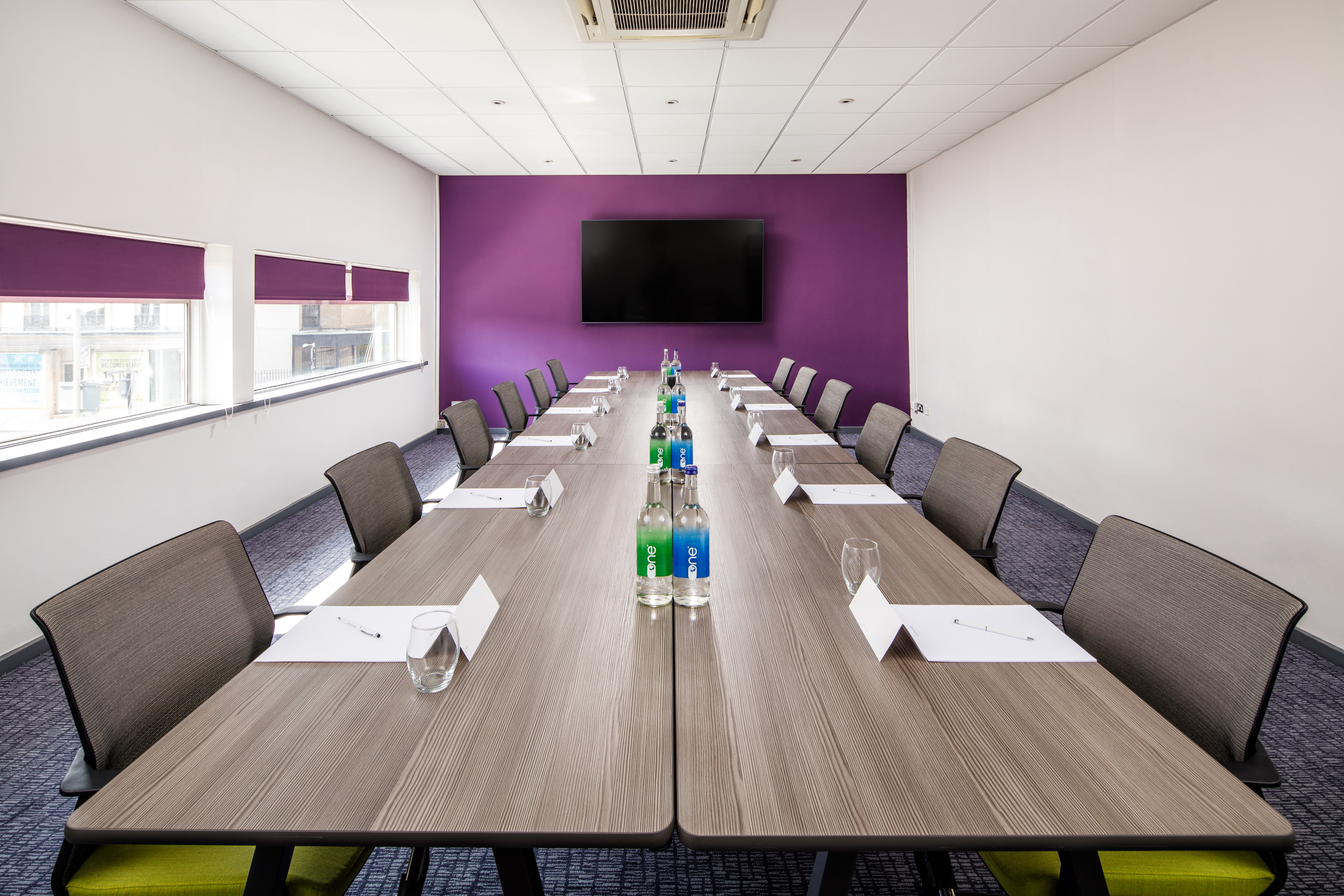 Meeting room at Mercure Bedford with purple wall, perfect for workshops and conferences.