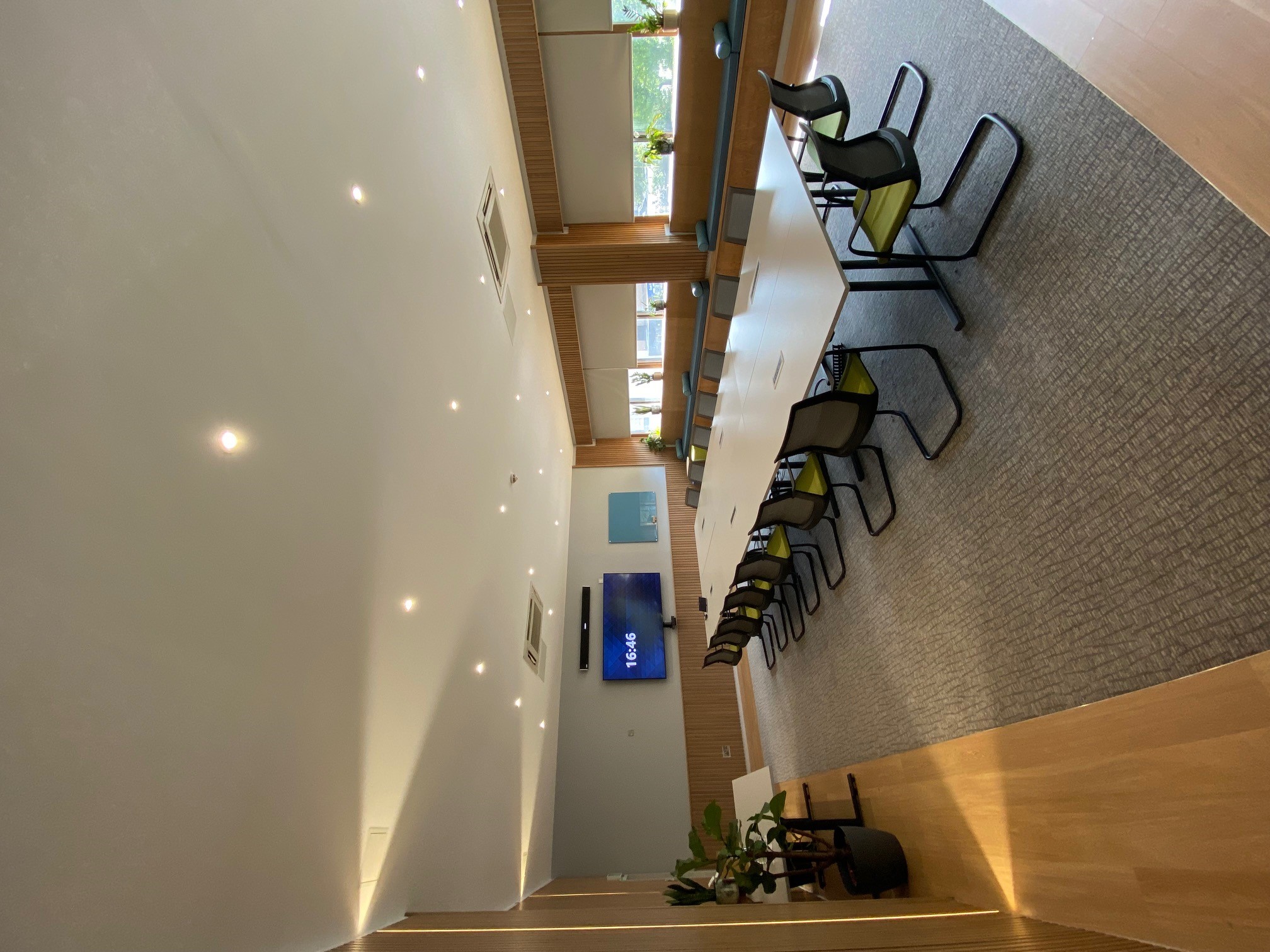 Modern meeting room at Mercure Bedford Hotel with large windows for collaboration.