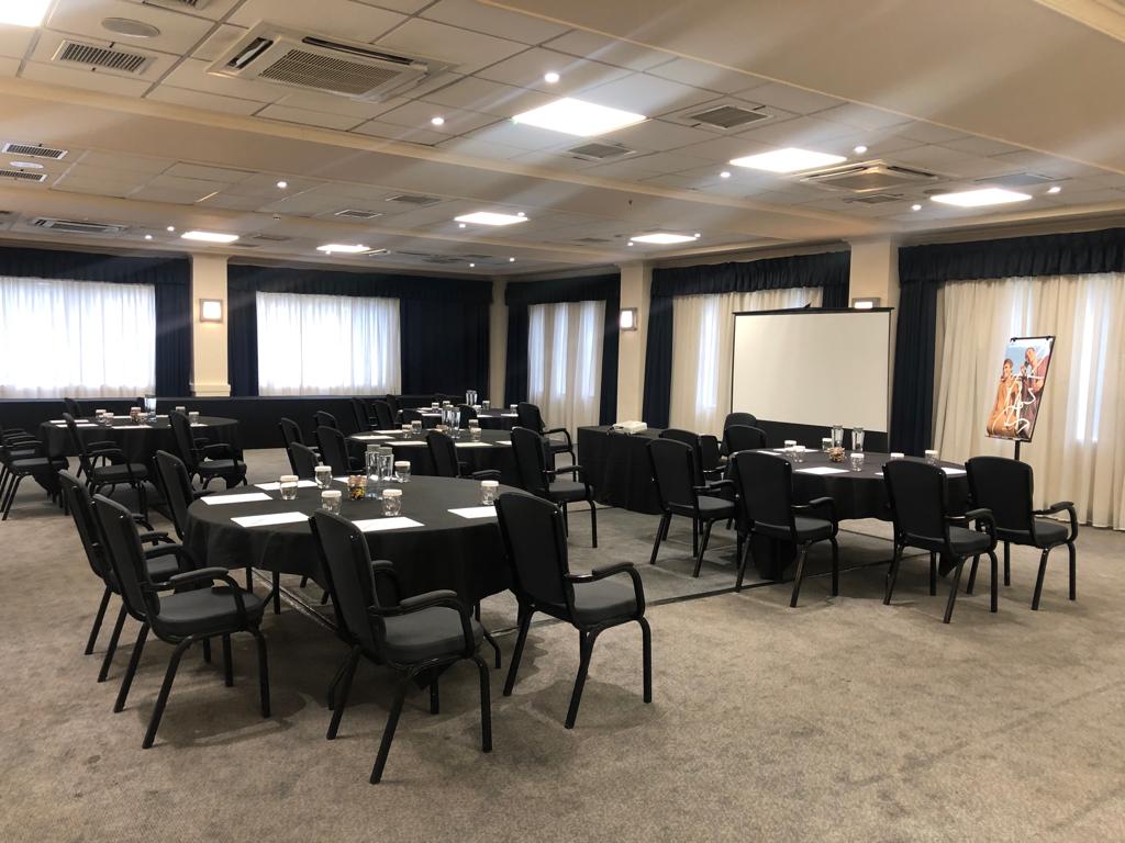 Carmarthen Suite meeting room with round tables, ideal for corporate events and workshops.