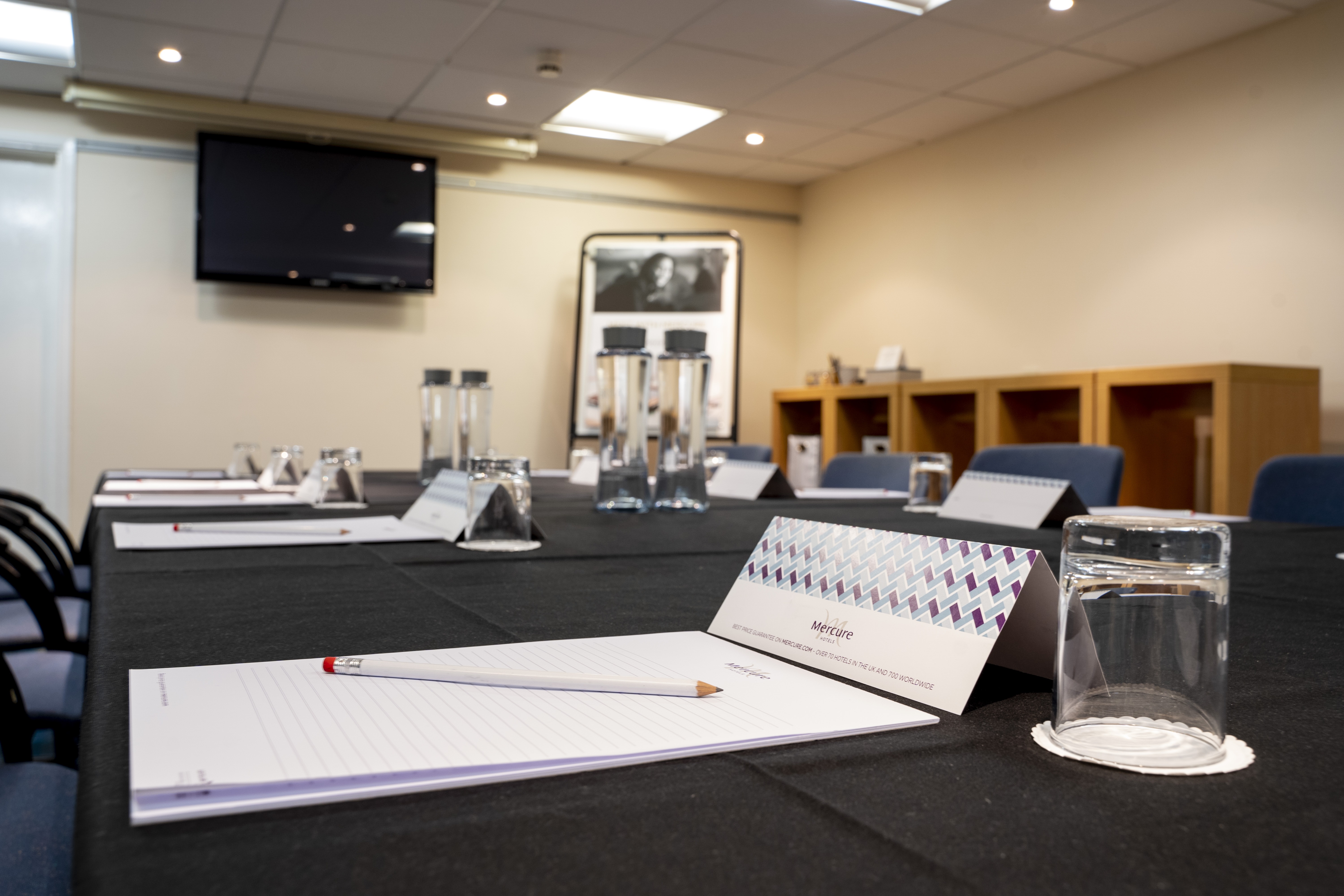 Meeting room at Mercure Cardiff North Hotel with sleek black table for professional events.