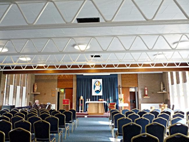 St John Fisher Church Hall with chairs arranged for community events and gatherings.