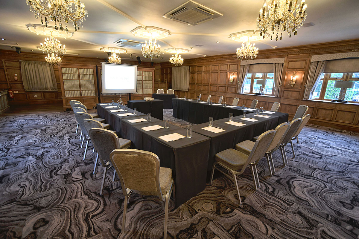 Function room in Rochdale with U-shaped tables for professional meetings and events.