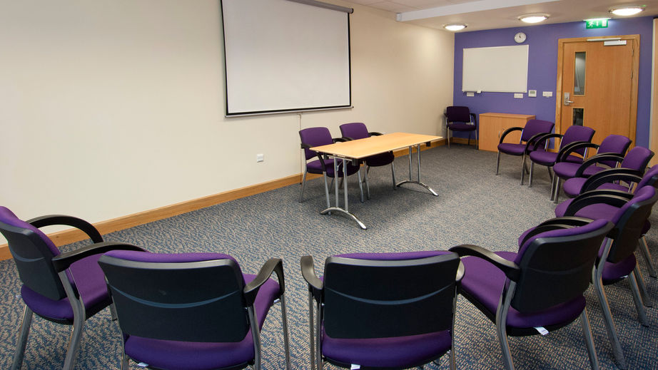 Meeting room with circular seating for workshops and presentations in Manchester City Centre.