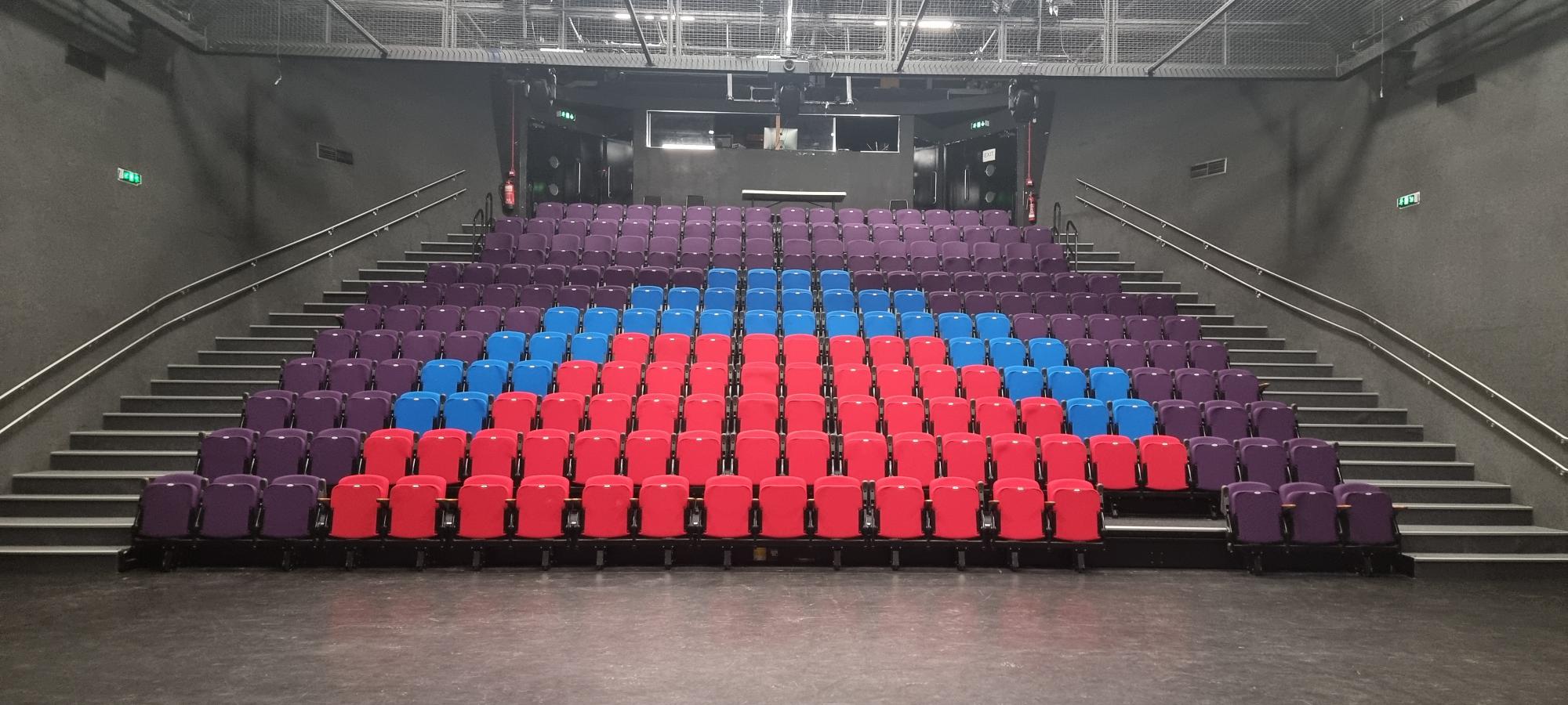 Vibrant tiered seating in Z-arts for engaging presentations and performances.